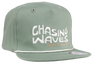The Chasing Snapback Hat is the perfect accessory for surf and beach lovers of all ages. Featuring an all-teal/green design with an embroidered "Chasing Waves BNKY Surf" logo on the front, this stylish hat is made from 100% high-quality cotton for comfort and durability. Available in infant, toddler, youth, junior, and adult sizes, it’s a great fit for the whole family. Whether you’re hitting the beach or enjoying a casual day out, this snapback hat combines coastal vibes with everyday functionality. Perfec