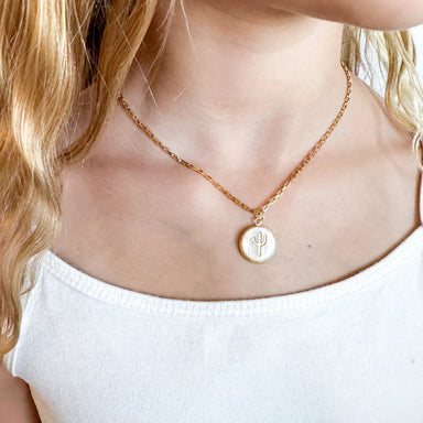 girl wearing Miminoo cactus charm necklace layered with gold chains – southwestern boho style