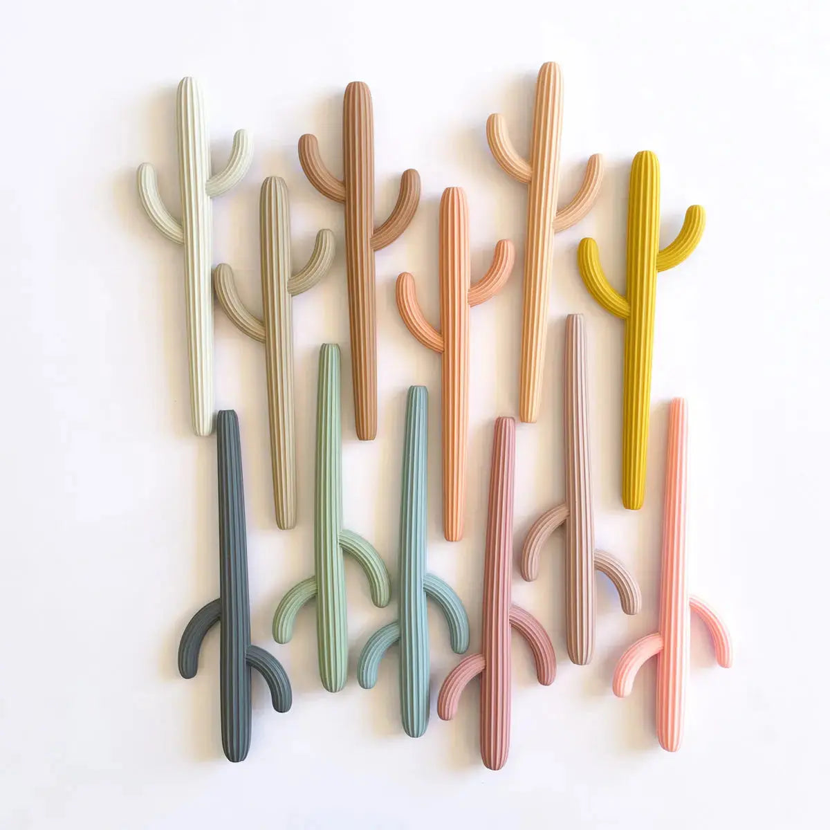 An assortment of pastel colored cactus silicon theethers and straws for toddlers and kids by Miminoo.