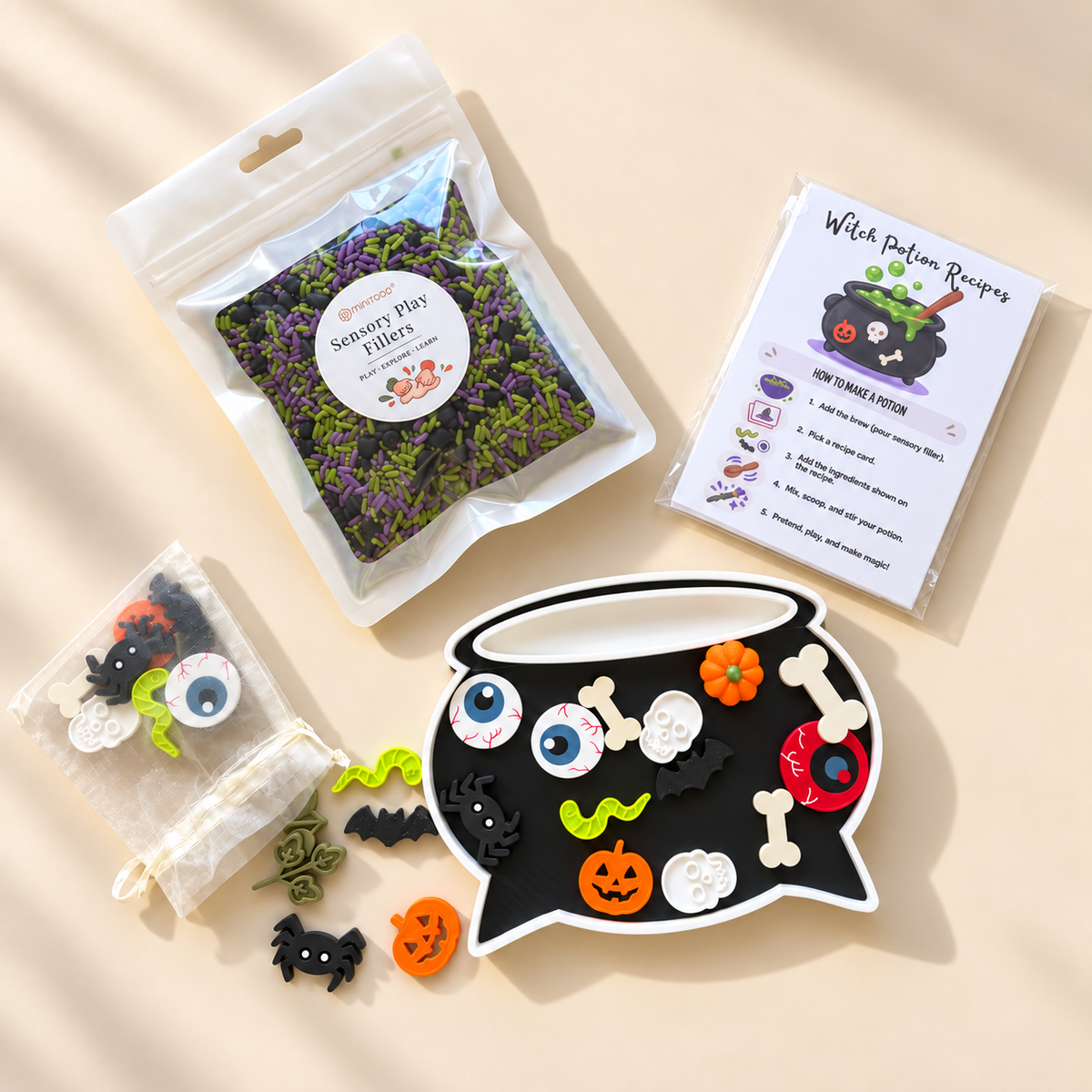 Halloween witches potion sensory play kit with black cauldron, sensory filler, 27 mini potion pieces and recipe cards.
