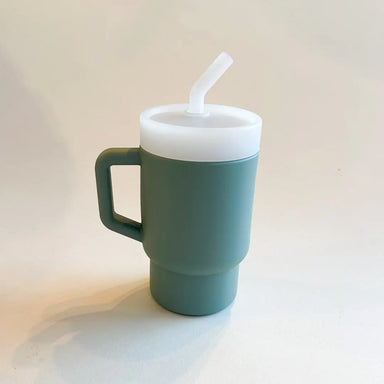 A lightweight 9oz toddler tumbler in soft, premium silicone, designed with a handle for easy grip and portability. The tumbler features a leak-resistant straw with a soft silicone tip, making it perfect for independent sipping. Available in playful colors for kids, it combines functionality with fun for little explorers. Light grey, unisex color for boys and girls.