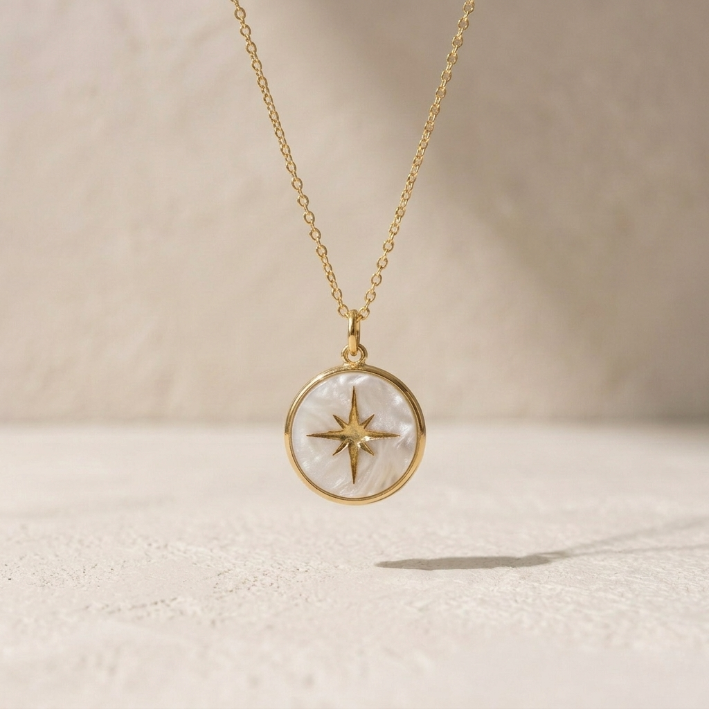 Gold necklace with a star pendant on a beige background
