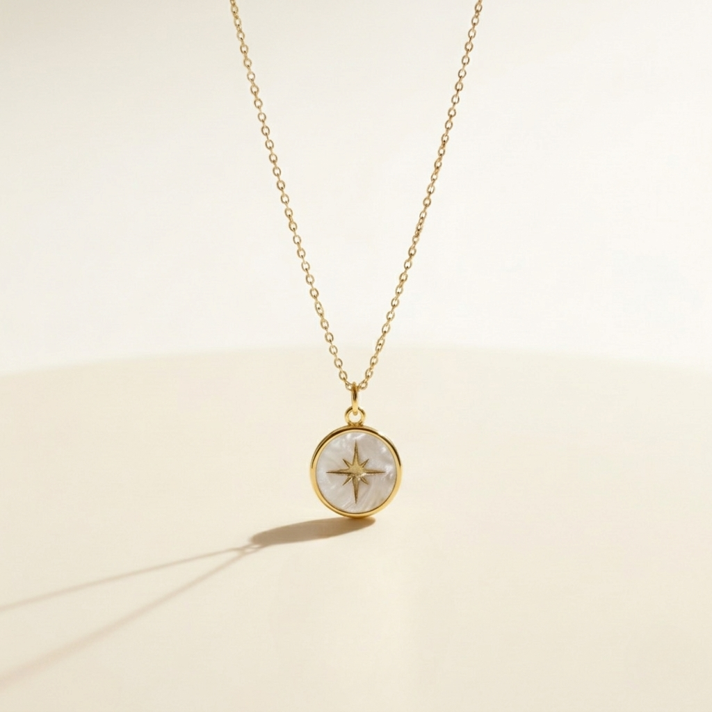 Gold necklace with a compass pendant on a beige background miminoo