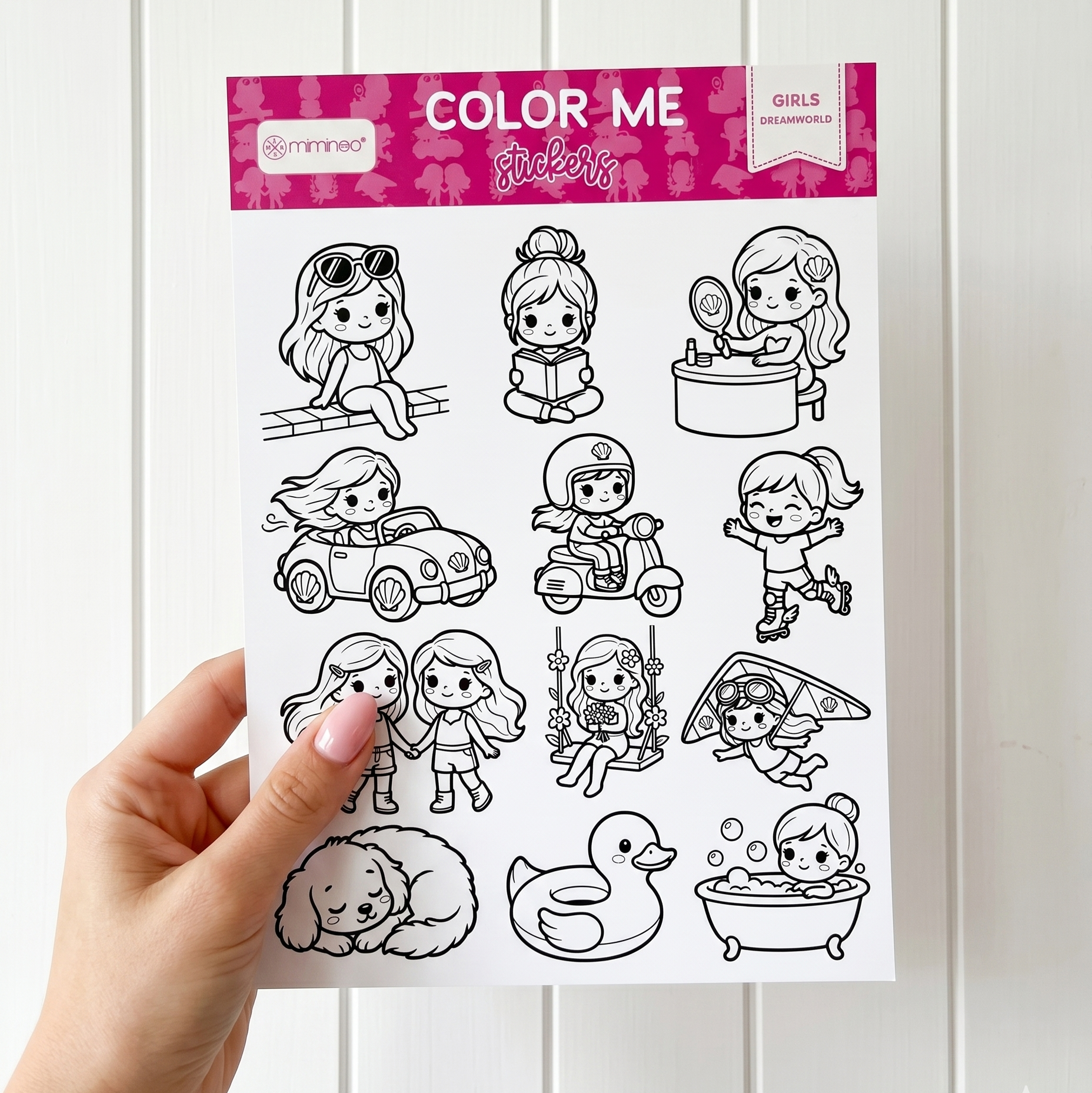 a hand holding a sticker sheet of girls cartoons