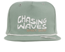 The Chasing Snapback Hat is the perfect accessory for surf and beach lovers of all ages. Featuring an all-teal/green design with an embroidered "Chasing Waves BNKY Surf" logo on the front, this stylish hat is made from 100% high-quality cotton for comfort and durability. Available in infant, toddler, youth, junior, and adult sizes, it’s a great fit for the whole family. Whether you’re hitting the beach or enjoying a casual day out, this snapback hat combines coastal vibes with everyday functionality. Perfec