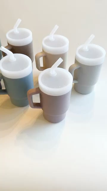 A lightweight 9oz toddler tumbler in soft, premium silicone, designed with a handle for easy grip and portability. The tumbler features a leak-resistant straw with a soft silicone tip, making it perfect for independent sipping. Available in playful colors for kids, it combines functionality with fun for little explorers.