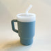 A lightweight 9oz toddler tumbler in soft, premium silicone, designed with a handle for easy grip and portability. The tumbler features a leak-resistant straw with a soft silicone tip, making it perfect for independent sipping. Available in playful colors for kids, it combines functionality with fun for little explorers. Denim blue, unisex color for boys and girls.
