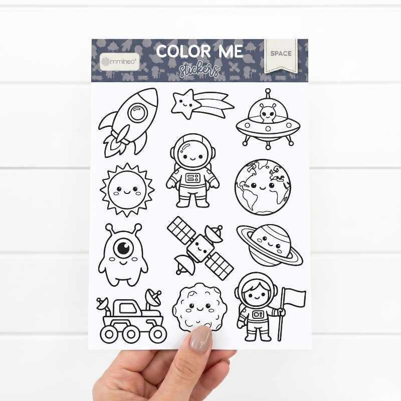 woman hand holding a sticker sheet to color on the space theme by miminoo